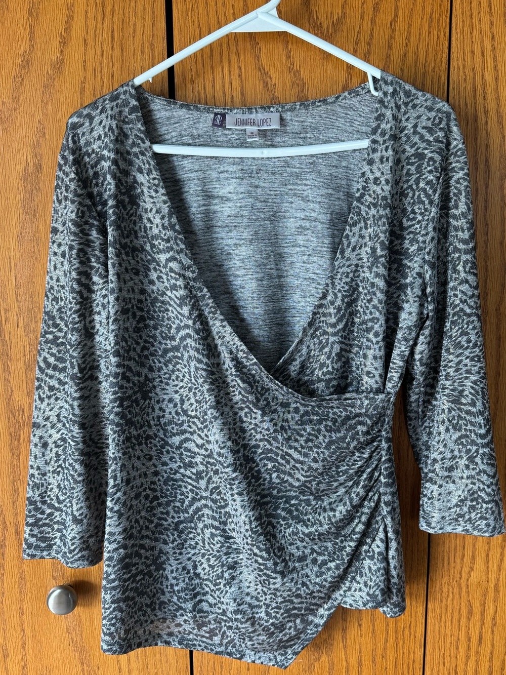 Jennifer Lopez Grey Animal Print Wrap Top with gold accent threading throughput